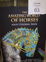 Front cover of 'The Amazing World of Horses' adult coloring book by Cindy Elsharouni, showing detailed horse illustrations partially colored.