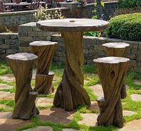 Complete set of one table and five stools arranged in a garden setting