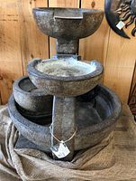 Front view of assembled three-tier cast stone fountain on display