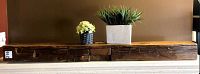 Full front view of wood beam mantel with decorative plants