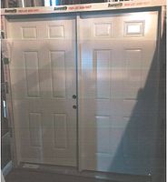 Two white six-panel door slabs in packaging, showing condition and design