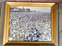 Full view of framed black and white photograph depicting a crowded Coney Island beach scene in mid-20th century style swimwear.