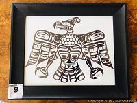 Frontal view of framed original pen and ink Thunderbird drawing in black wooden frame showing full artwork and signature.