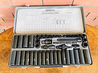 Top view of open socket set showing all sockets, ratchets, extensions and adapters organized in molded case