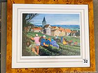 Full image of the framed artwork showing vineyard workers harvesting grapes in front of a French village.