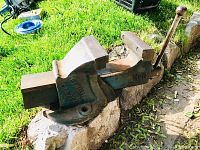 Side view of large heavy duty vise showing side markings and handle.