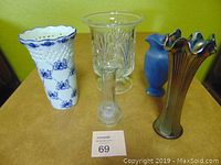 All five vases together showing variety in shapes and materials including ceramic, clear glass, and carnival glass.