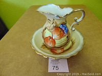 Water pitcher set on basin showing fruit design and scalloped gold edges