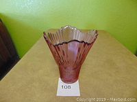 Side profile shot of the amethyst glass flared ribbed fluted vase showing shape, color and detail.