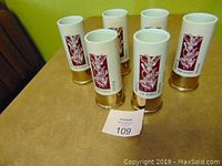Six Guerin Bouffioulx Belgique hunter vases arranged on a table, showing front view of decals and metallic bases