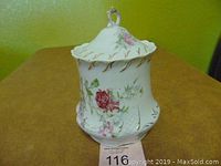 Front view of the vintage Dresden biscuit jar with lid on, showing floral design and gold accents