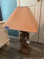 Full view of the vintage lamp showing the fabric shade with water damage and overall size.