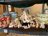 Full view of the Easter decor collection including various bunny figurines, plastic eggs, egg cartons, and table linens arranged on shelves.