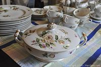 Front view of Lynmore Golden Rose fine china soup bowl with lid, showing floral rose patterns and gold-accented handles.