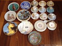 Wide view showing all tea cup sets and decorative plates arranged on floor