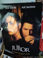 Movie poster featuring Demi Moore and Alec Baldwin titled 'The Juror' with close-up portraits
