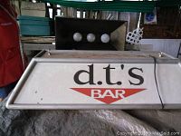 Front view of the d.t's BAR branded vintage hanging light with three bulbs visible inside the fixture