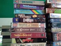 Stack of VHS tapes showing titles such as Desire, Telequarium, Munchkins, Dirty Pictures, Compulsion, Daughters of Darkness, The Canterbury Tales, The Cheap Detective