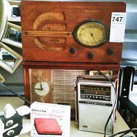 Westinghouse wood cabinet radio with carved speaker details and oval tuning dial above a General Electric portable radio and boxed Science Fair 2-Transistor AM Radio kit