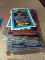 Stack of baseball cards showing card of player Walter Lyle on top, with other cards beneath it in protective plastic sleeves.