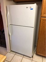 Front and side view of the full Kenmore refrigerator, showing the closed doors and overall condition.