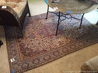 Full view of rug in room showing overall pattern, colors and condition