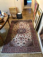 Full view of rectangular rug laid on parquet floor, showing overall design and pile condition