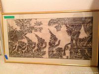 Framed black and white Thai temple stone rubbing laid flat showing entire artwork with traditional figures and temple reliefs.