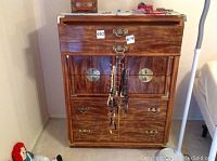 Front view of Bassett dresser showing the drawer configuration and metal handles with decorative corner brackets.