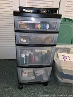 Full view of 4 drawer plastic storage unit with some visible craft supplies inside.