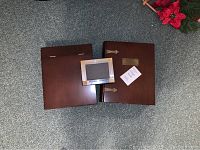 Top view of two wooden storage boxes and one metal picture frame on a carpeted floor