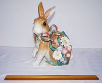 Front view of the Fitz and Floyd ceramic rabbit figurine showing floral details and bow.