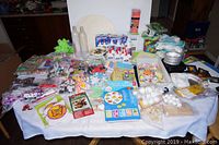Full lot of assorted kids' craft materials displayed on a table showing the contents including beads, glue, foam sheets, and trays.