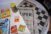 Close-up of individual game boxes and reversible checkers/tic tac toe mat