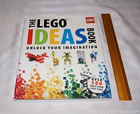 Front cover of The Lego Ideas Book showing colorful Lego blocks and models