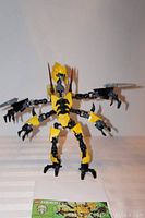 Front view of Lego Hero Factory Waspix figure 2231 displaying yellow and black spider-like design with multiple articulated limbs and claws.
