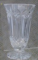 Side profile of clear waterford crystal footed vase with star and diamond cut pattern.