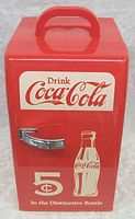 Front view showing Coca-Cola logo, vintage branding with price and bottle graphic, and chrome door handle.