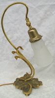 Side view of the lamp showing curved brass arm and etched frosted glass shade, highlighting decorative details and shape.