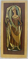 Full view of the wooden wall hanging with painted cut out figure of a medieval lady in geometric style over natural wood panel.