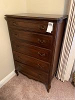 Full view of vintage highboy dresser showing its five drawers and curved feet.