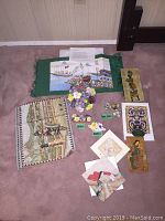 Full view of lot on carpet including bone china florals, table dressings like placemat, fabric cloths, and paper items.