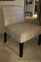 Front left angled view of slipper chair showing fabric pattern and legs