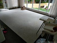 Full-room view of off-white chevron area rug under natural light, showing overall size and placement.