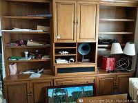 Front view of entire built-in bookcase showing all sections and loaded with items