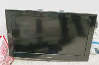 Front view of the black bezel Samsung TV screen showing the Samsung logo at the bottom center of the frame.