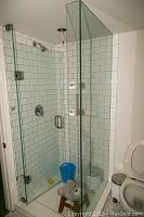 Full view of corner shower enclosure with glass panels and door