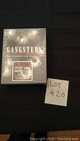 Shrink-wrapped black box set titled 'Gangsters The Ultimate Film Collection' with a sticker indicating included movies and features.