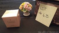 Overall lot showing perfume box, ceramic flowers, and cosmetic bag