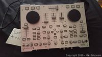 Overall front view of the Hercules DJ console showing jog wheels, multiple buttons, sliders and knobs.